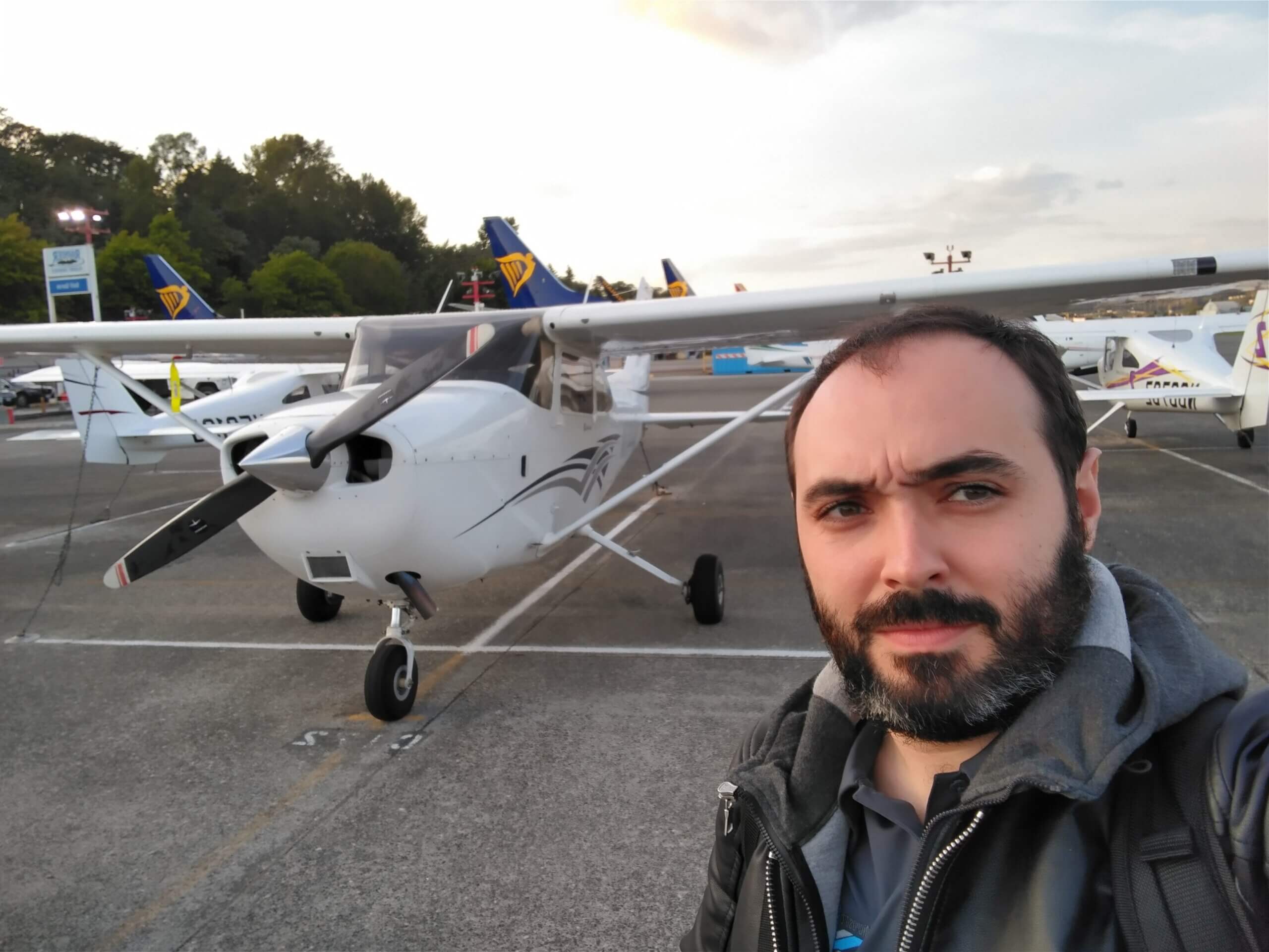 Lionel standing in front of a small plane