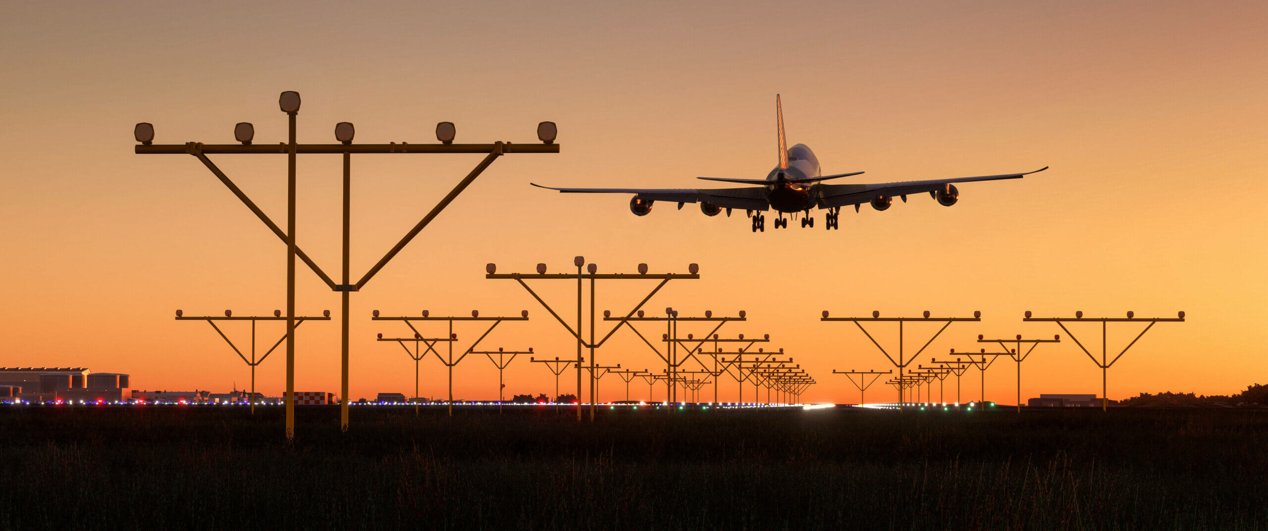 Plane coming in for final approach during sunset