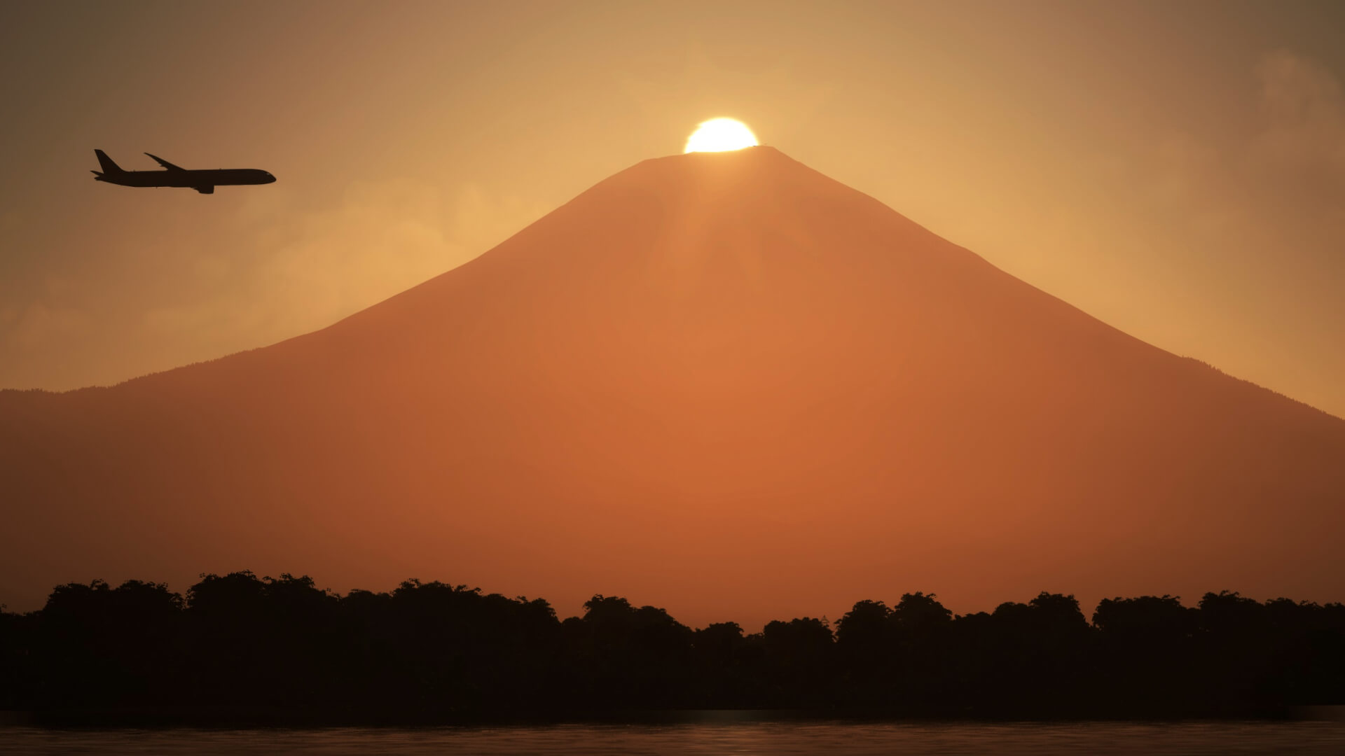 Sun peeks over a mountaintop